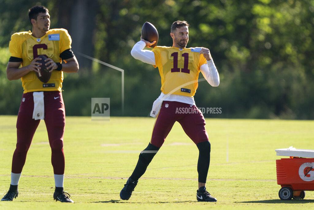 Alex Brandon Washington quarterback Alex Smith (11) throws, with quarterback Steven Montez (6) nearby, during practice at the team's NFL football training facility, Tuesday, Aug. 18, 2020, in Ashburn, Va. (AP Photo/Alex Brandon)