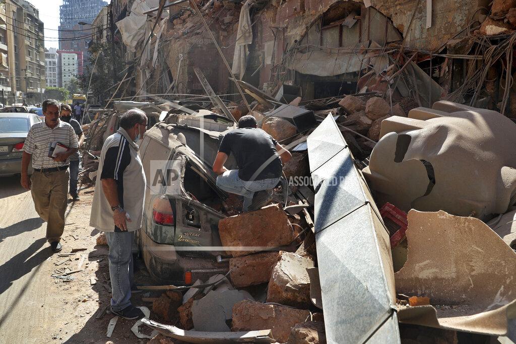 Bilal Hussein People inspect their car that was damaged in Tuesday's massive explosion in the seaport of Beirut, Lebanon, Wednesday, Aug. 5, 2020. The explosion flattened much of the port and damaged buildings across Beirut, sending a giant mushroom cloud into the sky. In addition to those who died, more than 3,000 other people were injured, with bodies buried in the rubble, officials said. (AP Photo/Bilal Hussein)