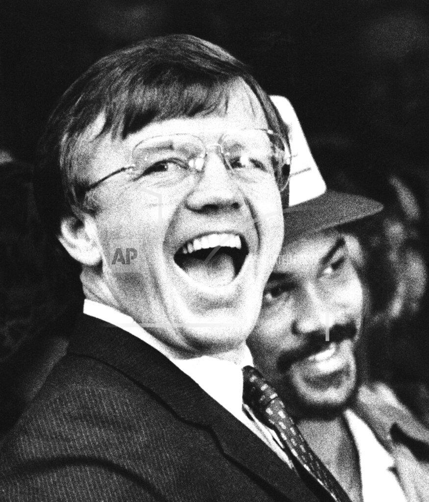 Anonymous FILE - In this Feb. 2, 1983, file photo, Washington Redskins head coach Joe Gibbs, left, and player Fred Dean react to the huge crowd that turned out to honor their victory over the Miami Dolphins in the Super Bowl, in Washington. Gibbs restored a winning culture to the Washington franchise, leading the Redskins to three Super Bowl appearances in the 1980s, including two victories. He'd win another in 1991. (AP Photo/File)
