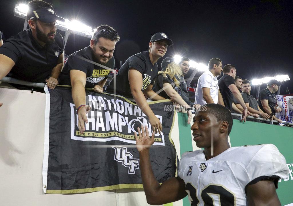 Mike Carlson Central Florida's Greg McCrae, right, celebrates with fans after a win over South Florida in an NCAA college football game Friday, Nov. 23, 2018, in Tampa, Fla. (AP Photo/Mike Carlson)