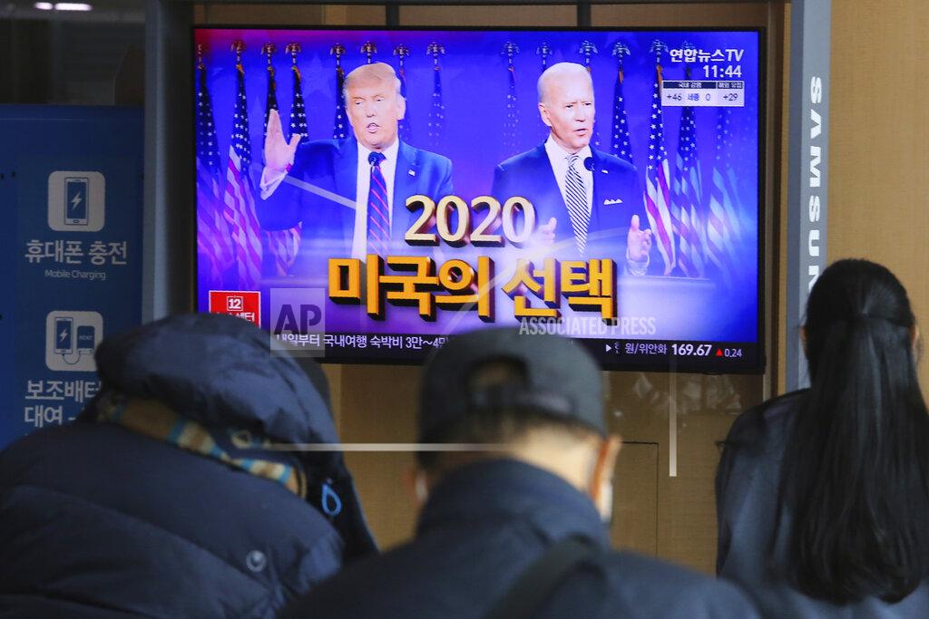 Ahn Young-Joon A TV screen shows images of U.S. President Donald Trump, left, and Democratic presidential candidate former Vice President Joe Biden during a news program at the Seoul Railway Station in Seoul, South Korea, Tuesday, Nov. 3, 2020. Nation by nation, how is Election Day in the United States being watched, considered, assessed? The Korean letters read "2020 America's Choice." For both North and South Korea, the fate of nuclear negotiations is top of mind as the two countries look at the U.S. election. (AP Photo/Ahn Young-joon)