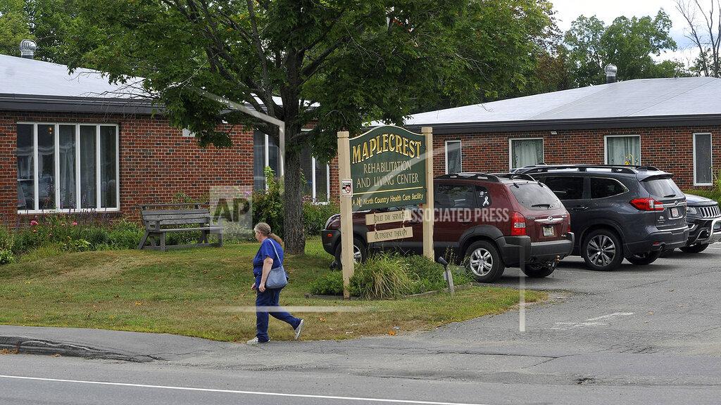 Rich Abrahamson In this Aug. 19, 2020, photo, a pedestrian walks past the Maplecrest Rehabilitation and Living Center shown in Madison, Maine. State health officials said a coronavirus outbreak at the rehabilitation center, where several have died, is connected to a COVID-19 outbreak at a wedding reception in Millinocket, as an employee of the facility lives in the same household as a person who attended. (Rich Abrahamson/The Central Maine Morning Sentinel via AP)