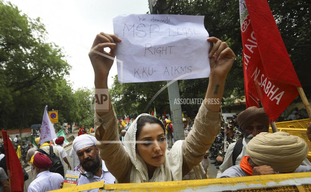 Manish Swarup A woman farmer holds a banner during a protest in New Delhi, India, Thursday, July 22, 2021. More than 200 farmers on Thursday began a protest near India's Parliament to mark eight months of their agitation against new agricultural laws that they say will devastate their income. (AP Photo/Manish Swarup)