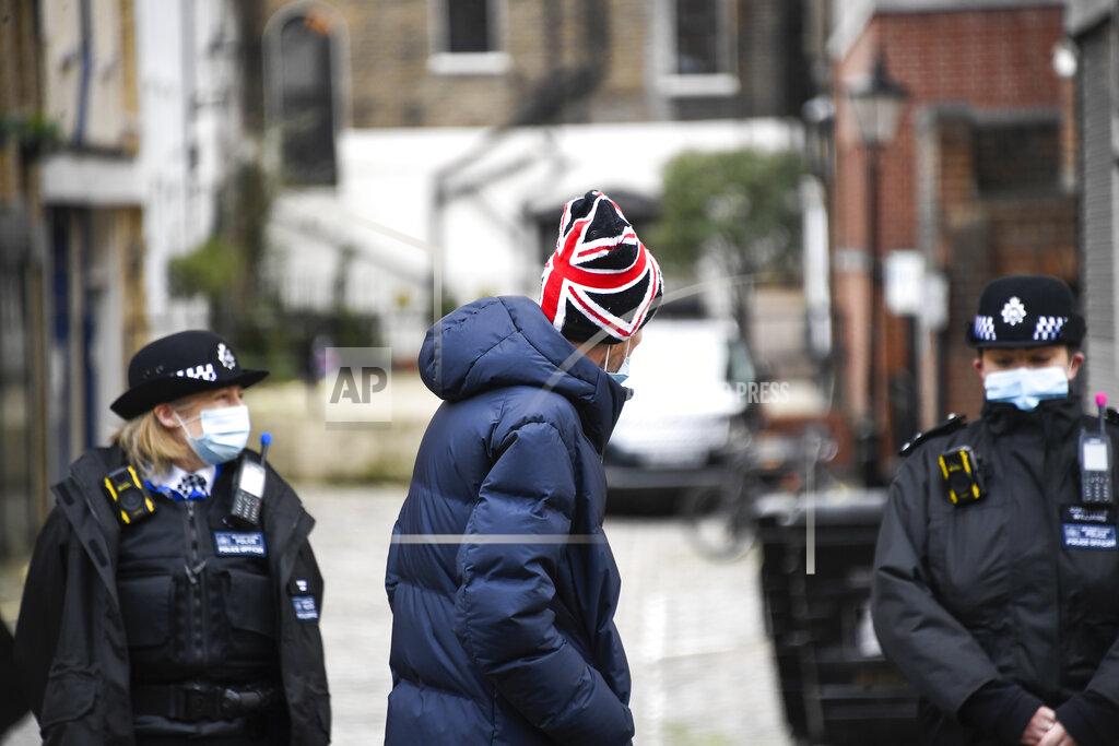 Alberto Pezzali A member of the public wearing a Union Flag themed hat walks past the side entrance of the King Edward VII Hospital in London, Sunday, Feb. 21, 2021. Buckingham Palace said the husband of Queen Elizabeth II, 99-year-old Prince Philip was admitted to the private King Edward VII Hospital on Tuesday evening after feeling unwell. (AP Photo/Alberto Pezzali)