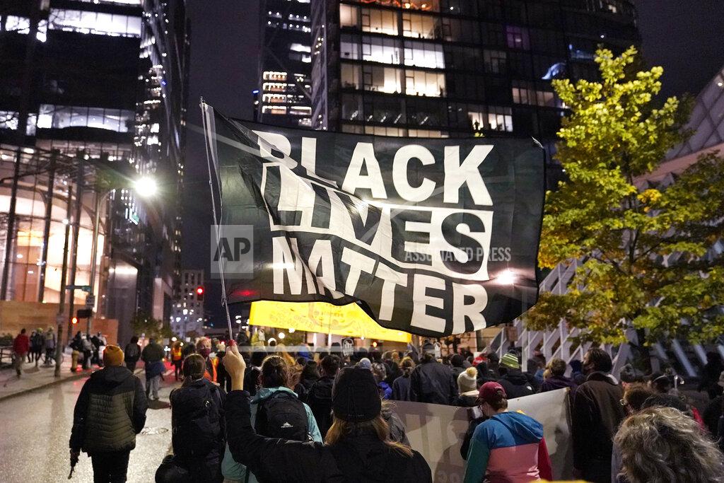 Ted S. Warren FILE - In this Nov. 4, 2020, file photo, protesters representing Black Lives Matter and Protect the Results march in Seattle. A financial snapshot shared exclusively with The Associated Press shows the Black Lives Matter Global Network Foundation took in just over $90 million last year. (AP Photo/Ted S. Warren, File)