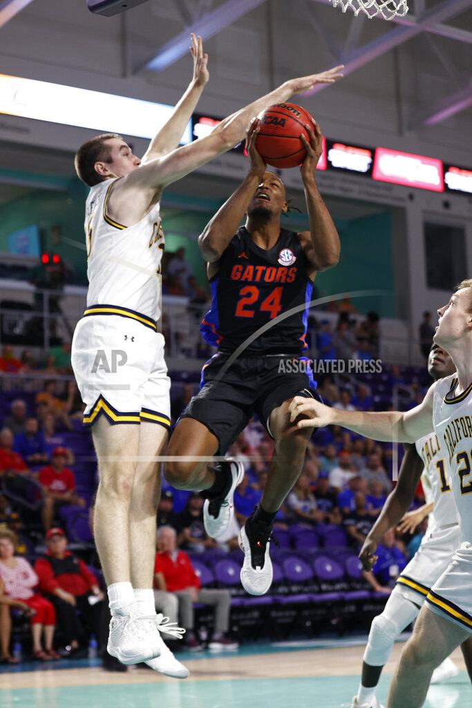 Scott Audette Florida guard Phlandrous Fleming Jr. (24) drives to the basket past California forward Grant Anticevich (15) during the first half of an NCAA college basketball game on Monday, Nov. 22, 2021, in Fort Myers, Fla. (AP Photo/Scott Audette)