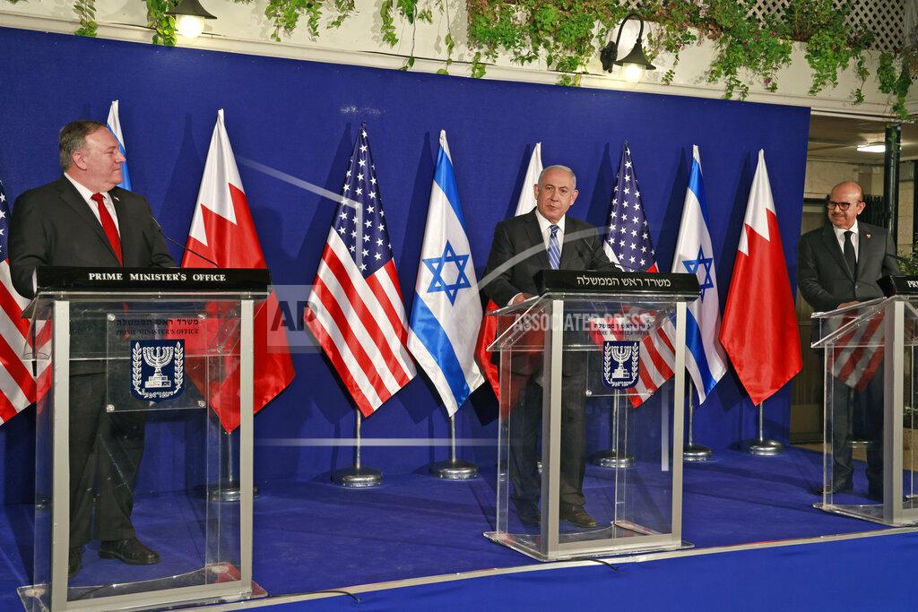 Menahem Kahana U.S. Secretary of State Mike Pompeo, left, and Bahrain's Foreign Minister Abdullatif bin Rashid Alzayani, right, listen as Israeli Prime Minister Benjamin Netanyahu speaks during a joint press conference after their trilateral meeting in Jerusalem on Wednesday, Nov. 18, 2020. (Menahem Kahana/Pool via AP)