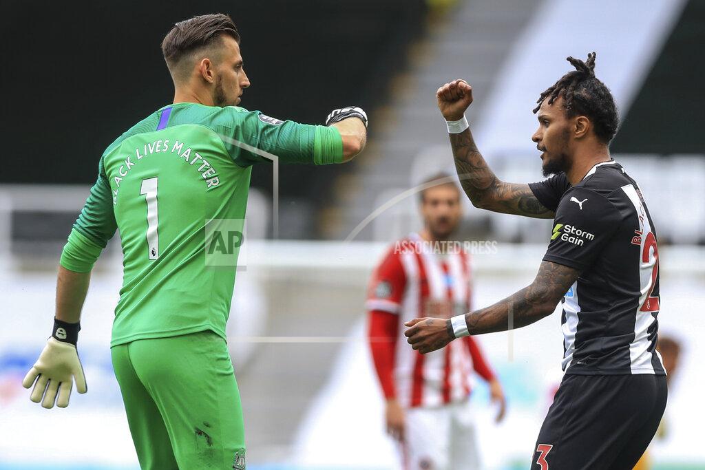 Owen Humphreys Newcastle's goalkeeper Martin Dubravka and teammate Valentino Lazaro elbow bump at the end of the English Premier League soccer match between Newcastle United and Sheffield United at St James' Park stadium in NewCastle, England, Sunday, June 21, 2020. (Owen Humphreys/Pool via AP)