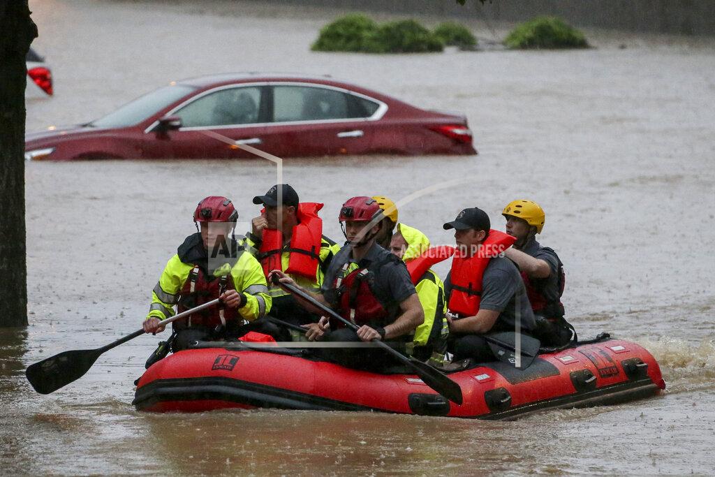 Butch Dill Residents of the Crescent at Lakeshore apartment complex are rescued by Homewood Fire and Rescue as severe weather produced torrential rainfall flooding several apartment buildings Tuesday, May 4, 2021 in Homewood, Ala. (AP Photo/Butch Dill)