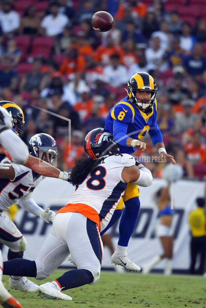 Mark J. Terrill Los Angeles Rams quarterback Brandon Allen, top, throws under pressure from Denver Broncos nose tackle Mike Purcell during the first half of an NFL preseason football game Saturday, Aug. 24, 2019, in Los Angeles. (AP Photo/Mark J. Terrill)