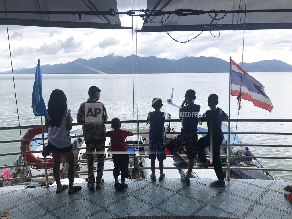 Passengers ride a ferry to the island of Koh Chang seen in the distance, Oct. 20, 2018, in southern Thailand. American expat Wesley Barnes, an English-language teacher in Thailand, was sued for criminal defamation by a hotel at which he stayed on the island because of derogatory reviews he posted online. He could face up to five years in prison on two charges if tried and found guilty. (AP photo/Wally Santana)
