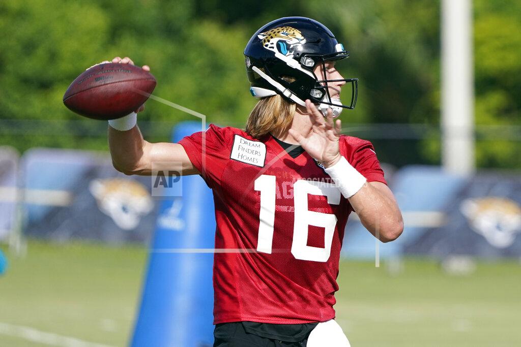 Jacksonville Jaguars quarterback Trevor Lawrence (16) throws a pass during an NFL football practice, Tuesday, July 26, 2022, in Jacksonville, Fla. (AP Photo/John Raoux)