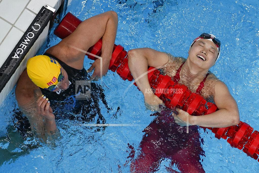 David J. Phillip Margaret MacNeil, right, of Canada, reacts after winning the final of the women's 100-meter butterfly as Sarah Sjoestroem, of Sweden, looks on at the 2020 Summer Olympics, Monday, July 26, 2021, in Tokyo, Japan. (AP Photo/David J. Phillip)