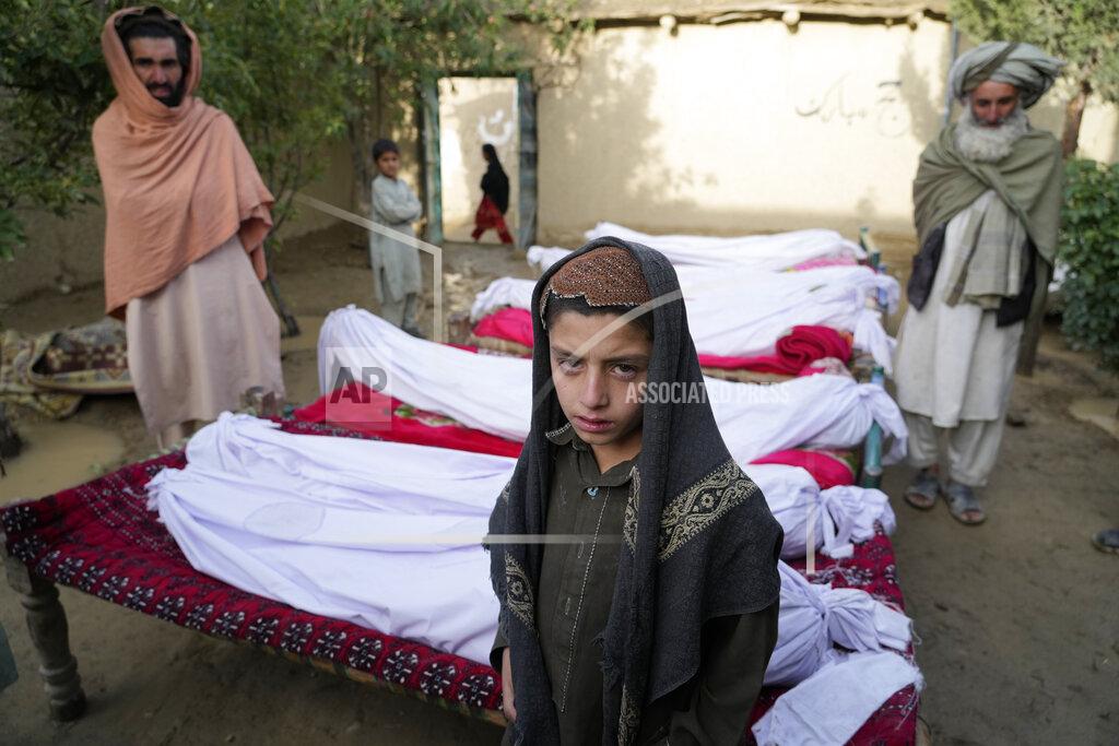 Ebrahim Noroozi Men stand around the bodies of people killed in an earthquake in Gayan village, in Paktika province, Afghanistan, Thursday, June 23, 2022. A powerful earthquake struck a rugged, mountainous region of eastern Afghanistan early Wednesday, flattening stone and mud-brick homes in the country's deadliest quake in two decades, the state-run news agency reported. (AP Photo/Ebrahim Nooroozi)