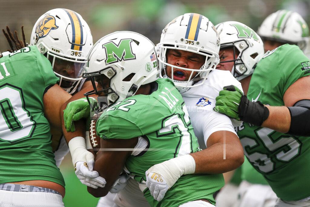 Sholten Singer Marshall running back Rasheen Ali (22) powers up the field on a carry against Florida International's Savion Collins (98) during an NCAA college football game Saturday, Oct. 30, 2021, in Huntington, W.Va. (Sholten Singer/The Herald-Dispatch via AP)