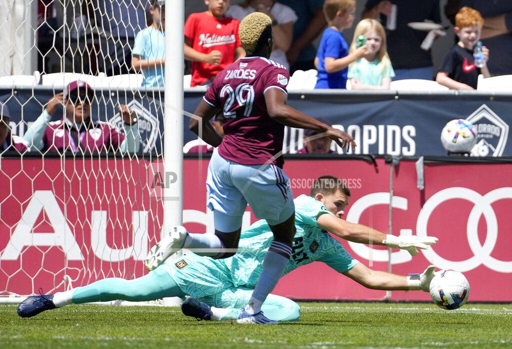 David Zalubowski Los Angeles FC goalkeeper John McCarthy, bottom, makes a save as Colorado Rapids attacker Gyasi Zardes closes in during the first half of an MLS soccer match Saturday, May 14, 2022, in Commerce City, Colo. (AP Photo/David Zalubowski)