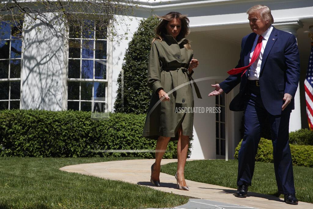President Donald Trump and first lady Melania Trump arrive for a tree planting ceremony to celebrate Earth Day, on the South Lawn of the White House, Wednesday, April 22, 2020, in Washington. (AP Photo/Evan Vucci)