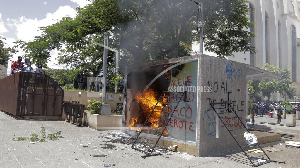 Ivan Manzano A Chivo digital wallet ATM, which exchanges cash for Bitcoin cryptocurrency, burns after being torched during a protest against President Nayib Bukele in San Salvador, El Salvador, Wednesday, Sept. 15, 2021. Thousands marched against the government of President Bukele, centered on fears Bukele may try for re-election in 2024. (AP Photo/Ivan Manzano)