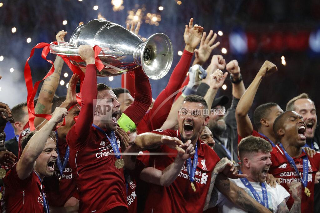 Felipe Dana Liverpool's players celebrate with the trophy after winning the Champions League final soccer match between Tottenham Hotspur and Liverpool at the Wanda Metropolitano Stadium in Madrid, June 2, 2019. Liverpool won 2-0. (AP Photo/Felipe Dana)