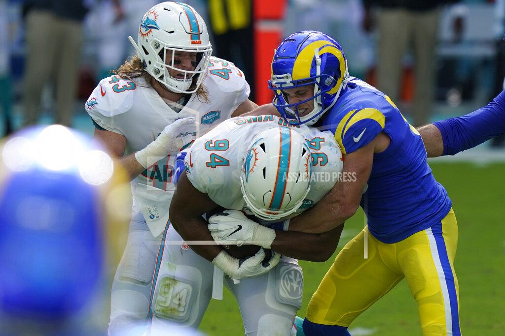 Lynne Sladky FILE - In this Nov. 1, 2020, file photo, Miami Dolphins defensive tackle Christian Wilkins (94) intercepts a pass intended for Los Angeles Rams wide receiver Cooper Kupp, righty, during the first half of an NFL football game, in Miami Gardens, Fla. The exuberant 315-pound tackle had a simple explanation for his first career interception, the kind of pivotal play that has become a habit for the Miami Dolphins' defense. “It’s all in the hips,” Wilkins said. (AP Photo/Lynne Sladky, File)