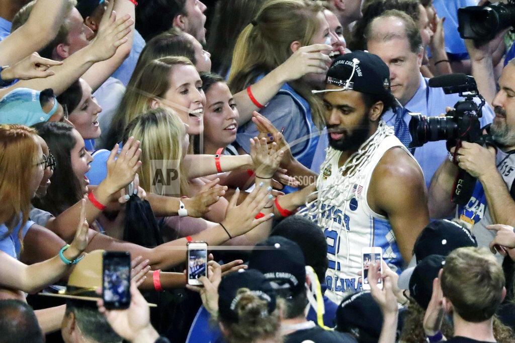 Matt York FILE - In this April 3, 2017, file photo, North Carolina guard Joel Berry II celebrates with fans after the championship game against Gonzaga at the Final Four NCAA college basketball tournament in Glendale, Ariz. North Carolina defeated Gonzaga 71-65. Berry was named MVP. (AP Photo/Matt York, File)