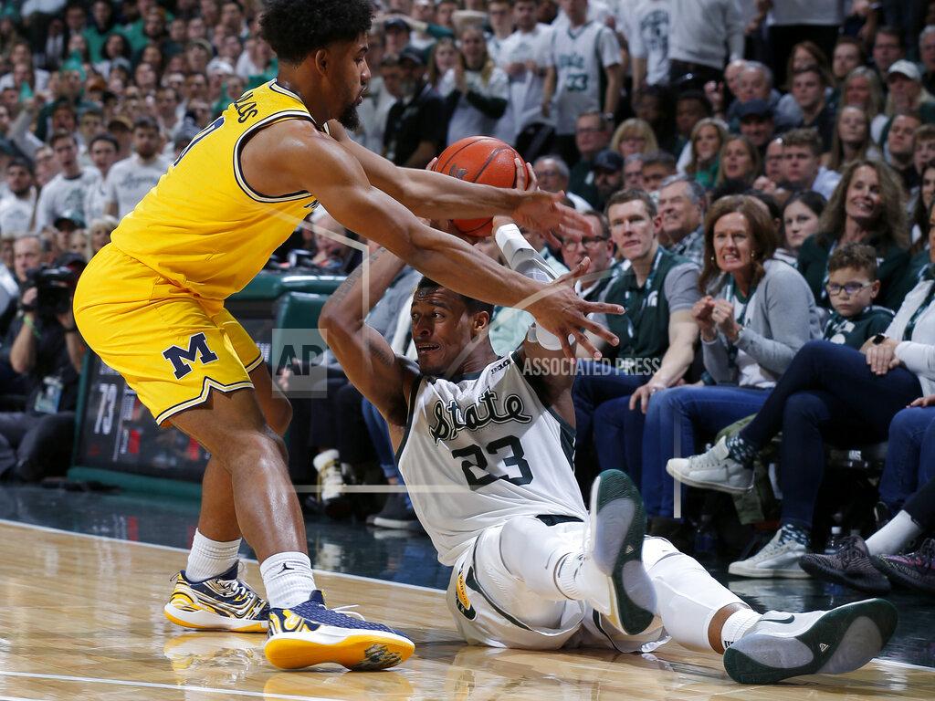 Al Goldis Michigan State's Xavier Tillman, right, and Michigan's David DeJulius battle for the ball during the second half of an NCAA college basketball game, Sunday, Jan. 5, 2020, in East Lansing, Mich. (AP Photo/Al Goldis)