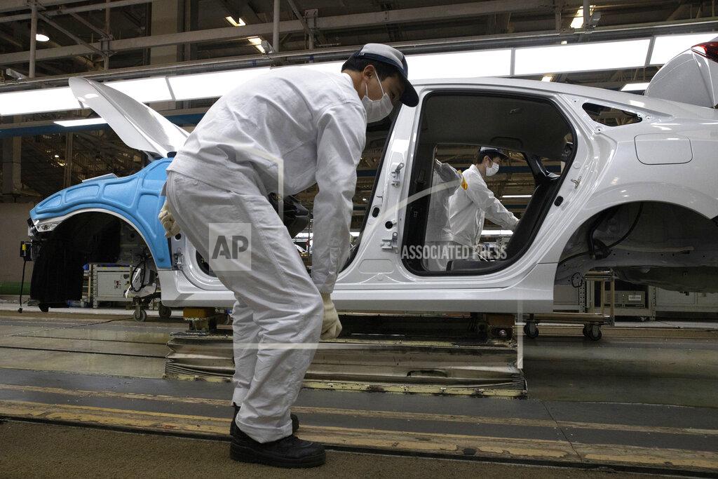 Ng Han Guan In this April 8, 2020, photo, employees work on a car assembly line at the Dongfeng Honda Automobile Co., Ltd factory in Wuhan in central China's Hubei province. The United States, Japan and France are prodding their companies to rely less on China to make the world’s smartphones, drugs and other products. But even after the coronavirus derailed global trade, few are willing to give up access to its skilled workers, vast market and efficient suppliers by moving factories closer to home. (AP Photo/Ng Han Guan)