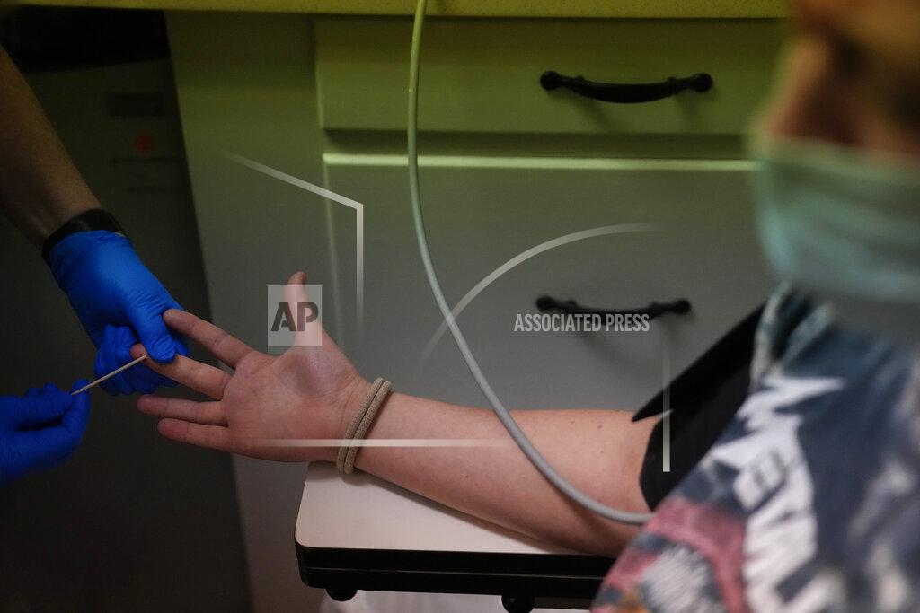 Rebecca Blackwell A 25-year-old from Texarkana, whose husband and nursing toddler waited for her outside in their car, has blood drawn ahead of being given pills and guidance for a medical abortion, Saturday, Oct. 9, 2021, at Hope Medical Group for Women in Shreveport, La. The nation's most restrictive abortion law is driving many women from Texas to seek services in neighboring states. The woman said she was already five weeks along before she realized she was pregnant, and she knew it would be impossible to schedule the required two visits at a Texas clinic. (AP Photo/Rebecca Blackwell)