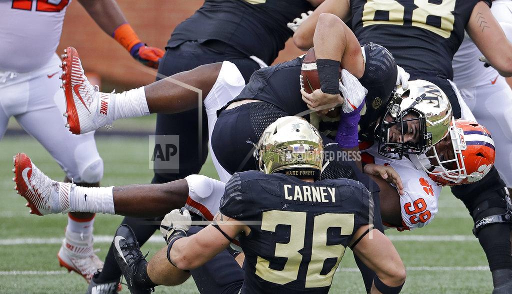 Chuck Burton Clemson's Clelin Ferrell (99) sacks Wake Forest's Sam Hartman, center, during the first half of an NCAA college football game in Charlotte, N.C., Saturday, Oct. 6, 2018. (AP Photo/Chuck Burton)