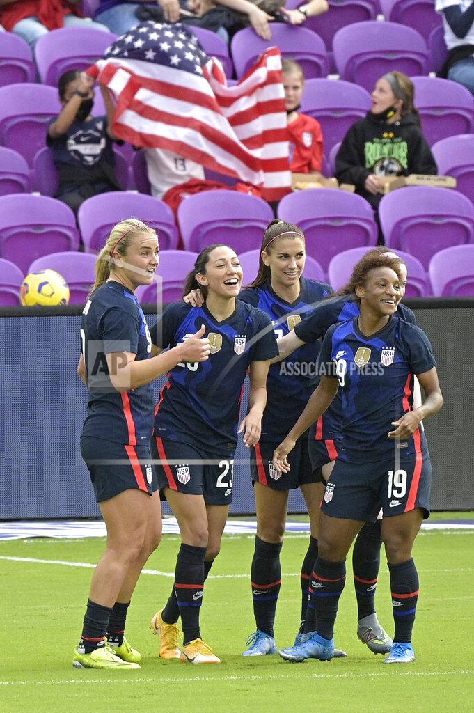 Phelan M. Ebenhack The United States forward Christen Press, second from left, is congratulated by teammates Lindsey Horan, left, Alex Morgan, and Crystal Dunn (19) after Press scored a goal during the first half of a SheBelieves Cup women's soccer match against Brazil, Sunday, Feb. 21, 2021, in Orlando, Fla. (AP Photo/Phelan M. Ebenhack)