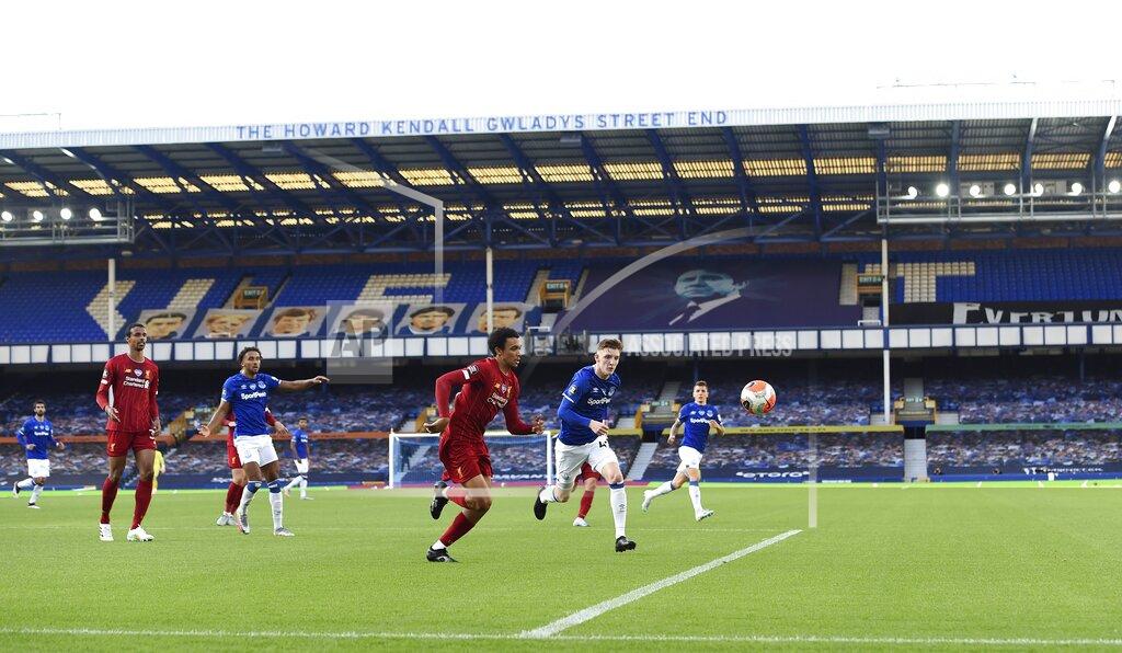 Peter Powell Players play in front of empty stands during the English Premier League soccer match between Everton and Liverpool at Goodison Park in Liverpool, England, Sunday, June 21, 2020. (Peter Powell/Pool via AP)