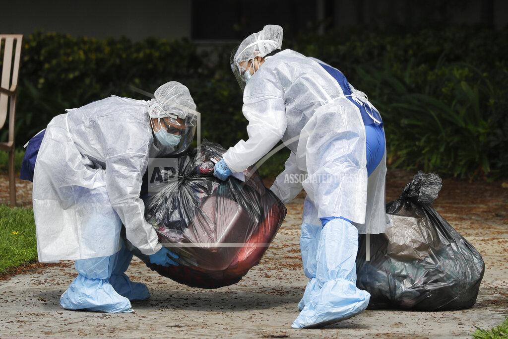 Chris Carlson Workers load the personal belongings of patient being evacuated from the Magnolia Rehabilitation and Nursing Center in Riverside, Calif., Wednesday, April 8, 2020. More than 80 patients from a Riverside skilled nursing facility are being evacuated this morning to other healthcare locations throughout Riverside County, Calif. (AP Photo/Chris Carlson)