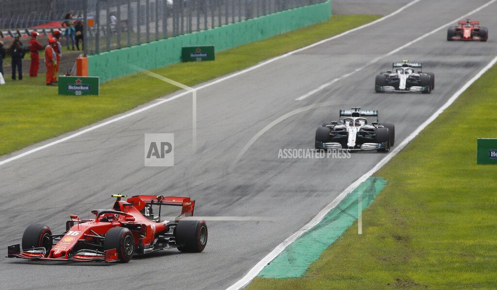 Antonio Calanni Ferrari driver Charles Leclerc of Monaco, left, leads the two Mercedes of Hamilton and Bottas and Ferrari driver Sebastian Vettel of Germany, during the first laps of the Formula One Italy Grand Prix at the Monza racetrack, in Monza, Italy, Sunday, Sept.8, 2019. (AP Photo/Antonio Calanni)