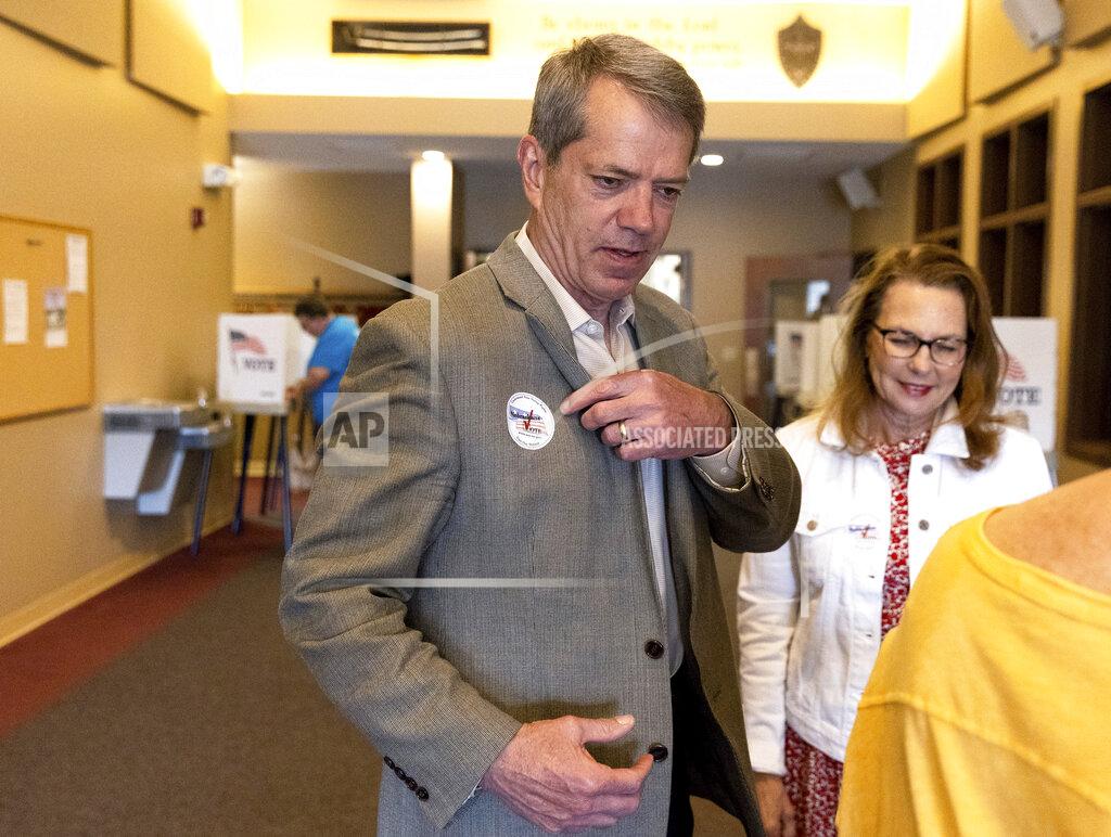 Eileen T. Meslar Jim Pillen receives a sticker after voting at his polling place, Columbus Berean Church, in Columbus, Neb., on Tuesday, May 10, 2022. (Eileen T. Meslar/Omaha World-Herald via AP)