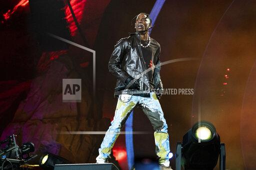 FILE - Travis Scott performs at Day 1 of the Astroworld Music Festival at NRG Park on Friday, Nov. 5, 2021, in Houston. Several families of the 10 people who died from injuries in the crush of fans at the Astroworld festival have turned down an offer by headliner Scott to pay for their loved ones’ funeral costs. (Photo by Amy Harris/Invision/AP, File)