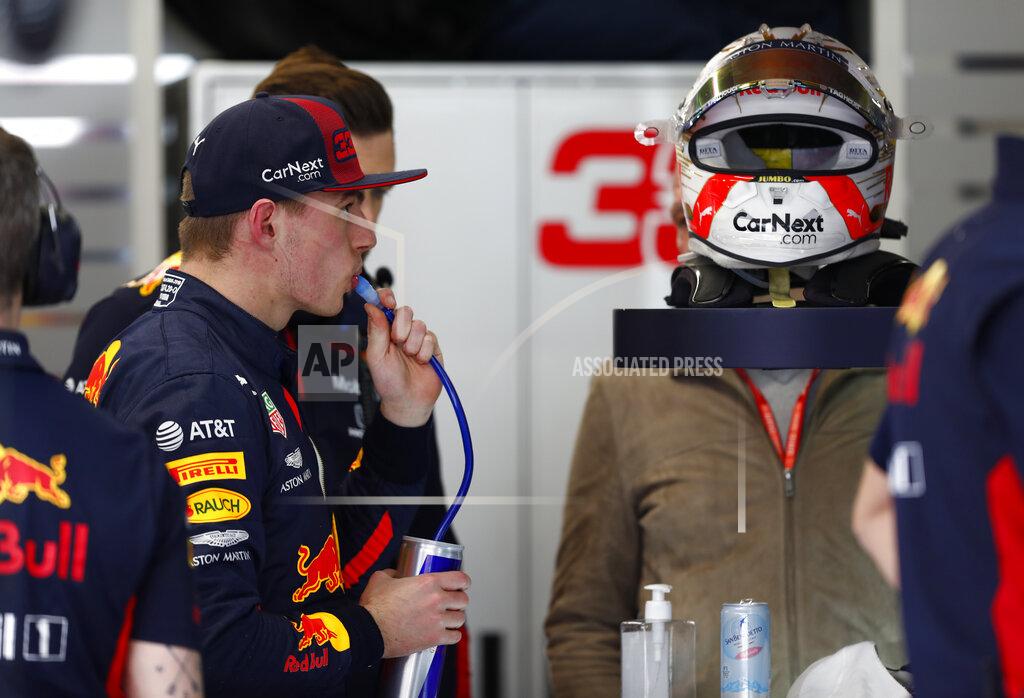 Joan Monfort Red Bull driver Max Verstappen of the Netherlands, second left, drinks as he waits in his garage during the Formula One pre-season testing session at the Barcelona Catalunya racetrack in Montmelo, outside Barcelona, Spain, Friday, Feb. 28, 2020. (AP Photo/Joan Monfort)