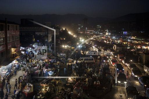 Afghans shop at a local market in Kabul, Afghanistan, Sunday, Sept. 26, 2021. (AP Photo/Felipe Dana)