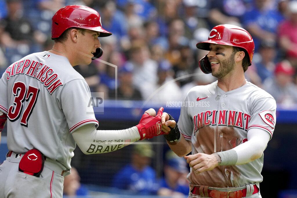 Frank Gunn Cincinnati Reds' Tyler Naquin, right, celebrates with teammate Tyler Stephenson (37) after scoring on a double by teammate Joey Votto during the fourth inning of a baseball game against the Toronto Blue Jays in Toronto, Saturday, May 21, 2022. (Frank Gunn/The Canadian Press via AP)