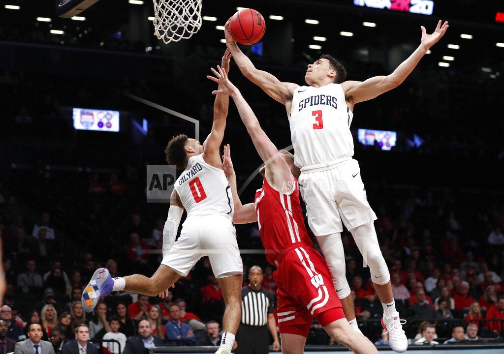 Kathy Willens Richmond forward Tyler Burton (3) grabs a rebound as Richmond guard Jacob Gilyard (0) tips the ball toward him and away from Wisconsin guard Brevin Pritzl (1) during the first half of an NCAA college basketball game in the Legends Classic, Monday, Nov. 25, 2019, in New York. (AP Photo/Kathy Willens)
