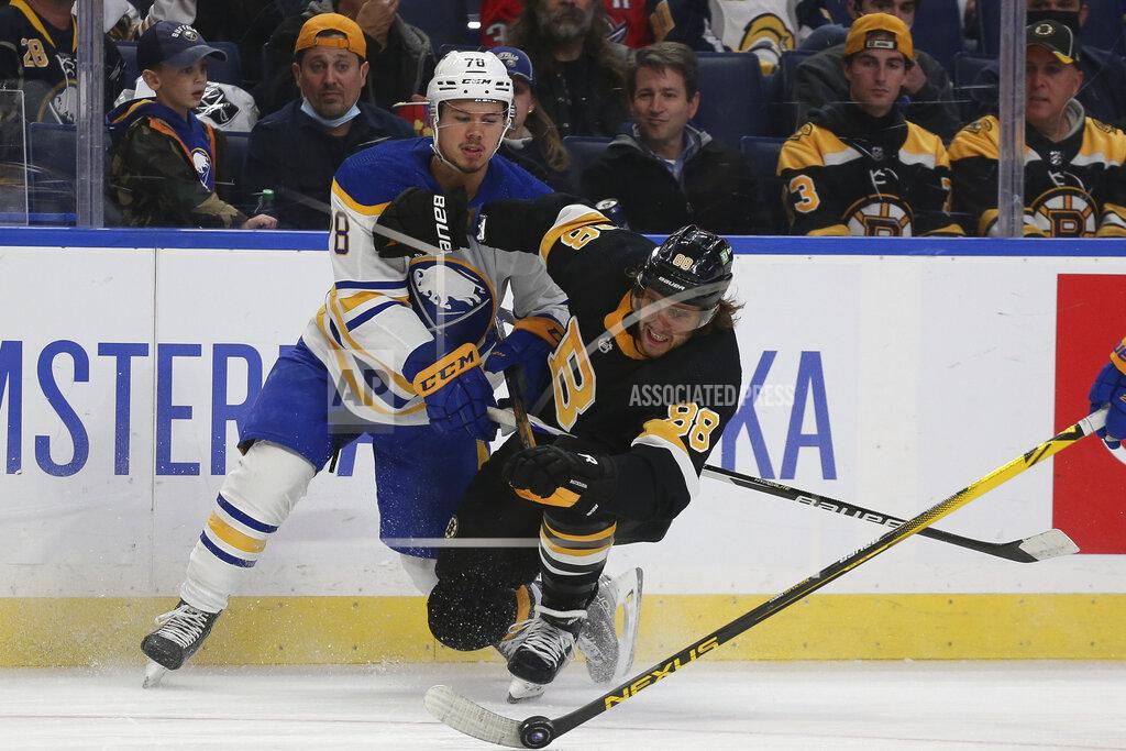 Joshua Bessex Boston Bruins right wing David Pastrnak (88) and Buffalo Sabres defenseman Jacob Bryson (78) collide while going after the puck during the second period of an NHL hockey game Friday, Oct. 22, 2021, in Buffalo, N.Y. (AP Photo/Joshua Bessex)