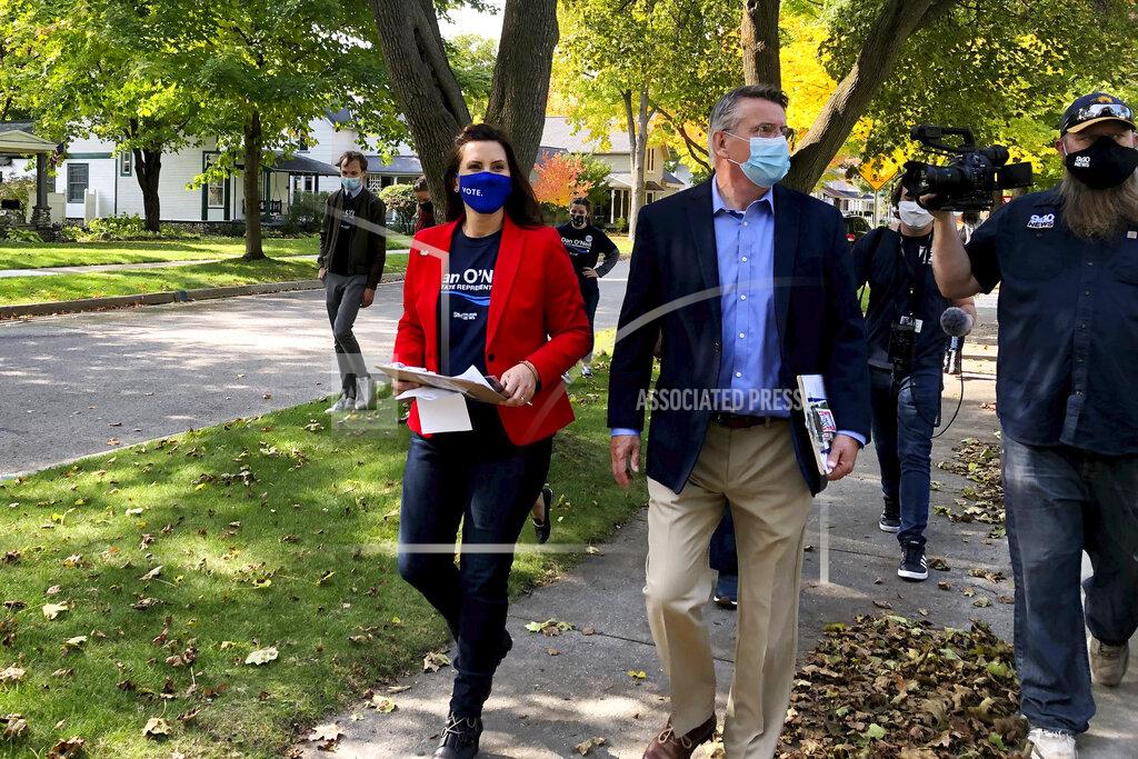 Michigan Gov. Gretchen Whitmer campaigns with Dan O'Neil, a Democratic candidate for the Michigan House in Traverse City, Mich., Friday, Oct. 9, 2020. Whitmer visited the area the day after police announced a foiled plot to kidnap the governor. (AP Photo/John Flesher)