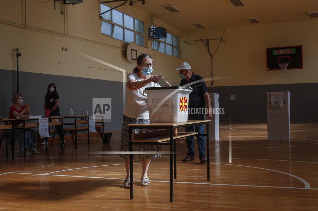 Boris Grdanoski A woman wearing a face mask casts her ballot at a polling station in Skopje, North Macedonia on Wednesday, July 15, 2020. Voters in North Macedonia were heading to polls early on Wednesday in the country's general election despite an alarming spike in coronavirus cases in the tiny Balkan nation. (AP Photo/Boris Grdanoski)