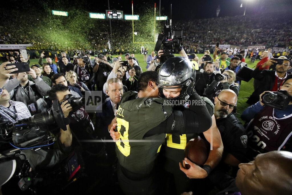Marcio Jose Sanchez Oregon quarterback Justin Herbert, right, hugs offensive lineman Penei Sewell after their win against Wisconsin in the Rose Bowl NCAA college football game Wednesday, Jan. 1, 2020, in Pasadena, Calif. (AP Photo/Marcio Jose Sanchez)