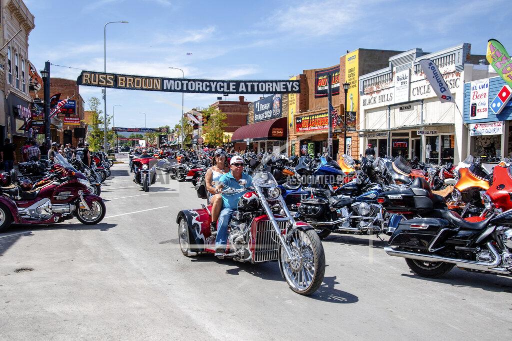 FILE - In this Aug. 15, 2020 file photo, bikers ride down Main Street during the 80th annual Sturgis Motorcycle Rally in Sturgis, S.D. This summer’s huge motorcycle rally in South Dakota led to dozens of coronavirus cases in neighboring Minnesota. That’s the finding of a report Friday, Nov. 20, from the Centers for Disease Control and Prevention. (Amy Harris/Invision/AP)