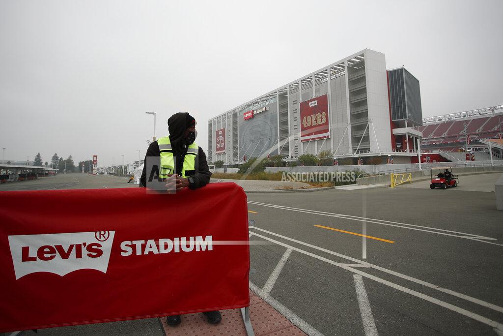 Josie Lepe A worker stands outside of Levi's Stadium before an NFL football game between the San Francisco 49ers and the Arizona Cardinals in Santa Clara, Calif., Sunday, Sept. 13, 2020. (AP Photo/Josie Lepe)