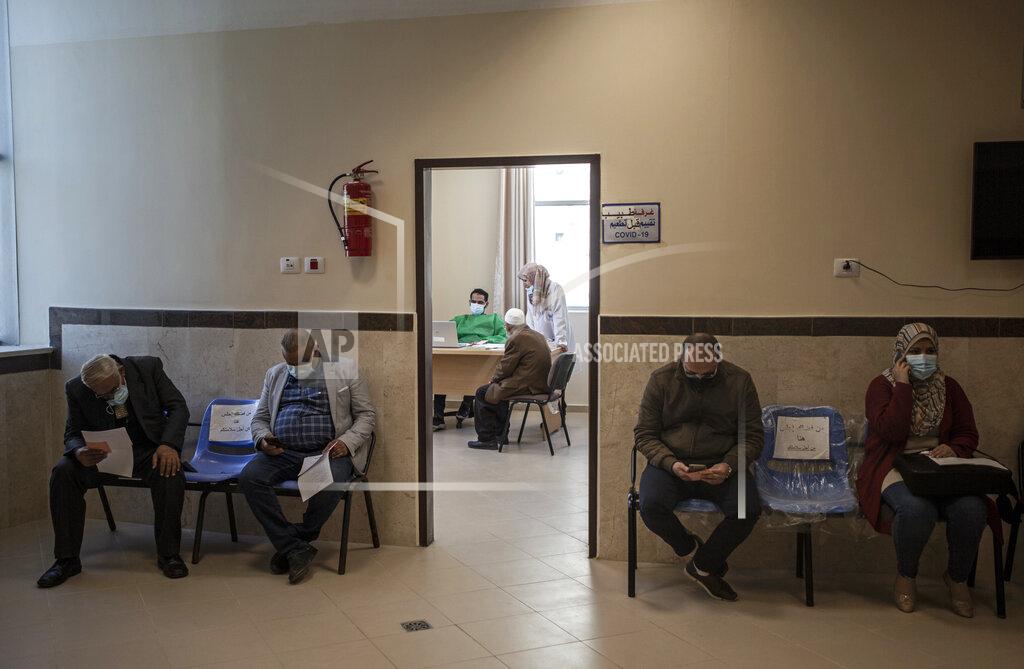 Khalil Hamra Palestinians wait for their turn to receive a shot of the Russian-made Sputnik V coronavirus vaccine at an UNRWA clinic in Gaza City, Wednesday, March 17, 2021. The Palestinian Authority says it will receive 62,000 coronavirus vaccine doses through a World Health Organization partnership designed to help poor countries. (AP Photo/Khalil Hamra)