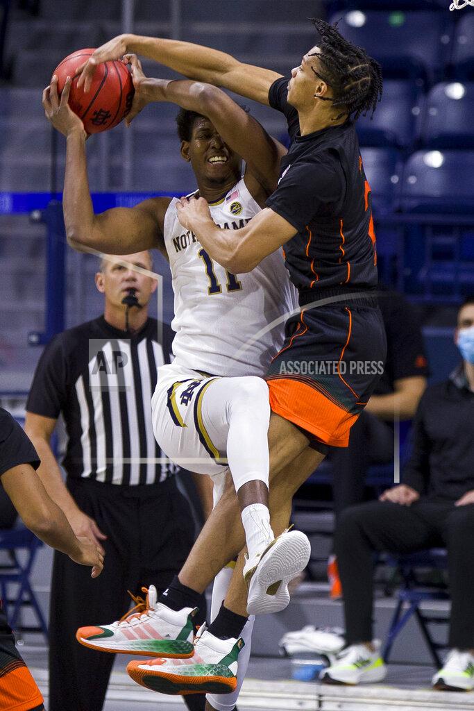 Robert Franklin Notre Dame's Juwan Durham (11) goes up to shoot with pressure from Miami's Isaiah Wong (2) during the first half of an NCAA college basketball game Sunday, Feb. 14, 2021, in South Bend, Ind. (AP Photo/Robert Franklin)