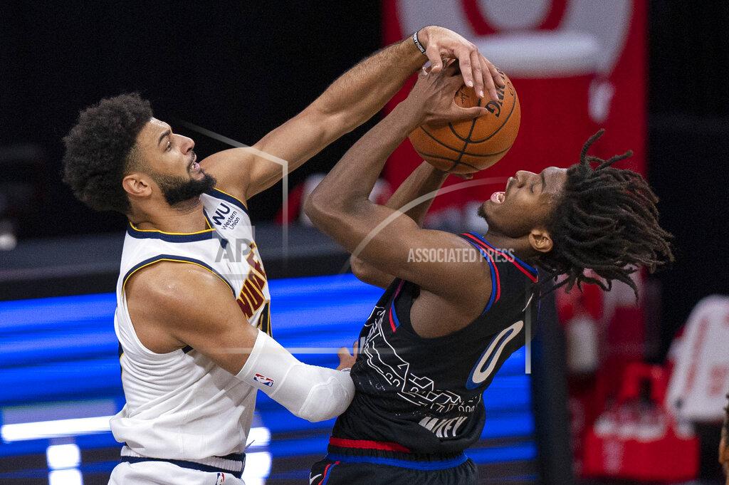 Chris Szagola Denver Nuggets' Jamal Murray, left, blocks the shot attempt by Philadelphia 76ers' Tyrese Maxey, right, during the first half of an NBA basketball game, Saturday, Jan. 9, 2021, in Philadelphia. (AP Photo/Chris Szagola)