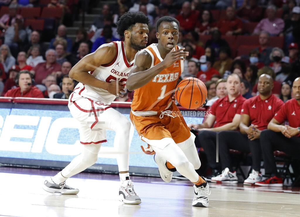 Alonzo Adams Texas guard Andrew Jones (1) drives to the basket past Oklahoma guard Elijah Harkless (55) during the first half of an NCAA college basketball game Tuesday, Feb. 15, 2022, in Norman, Okla. (AP Photo/Alonzo Adams)