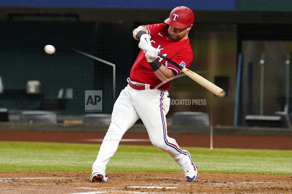Lm Otero Texas Rangers' Kole Calhoun hits a single during the second inning of the team's baseball game against the Boston Red Sox in Arlington, Texas, Friday, May 13, 2022. (AP Photo/LM Otero)